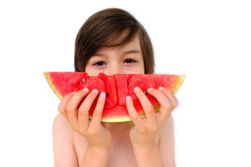 close-up of happy cool trendy funky brunette boy eating ripe red watermelon, juicy slice in hands of child, happy childhood, good appetite, balanced diet, sweet life, healthy food