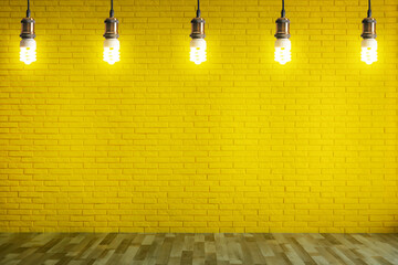 many pendant lamps in room with yellow brick wall
