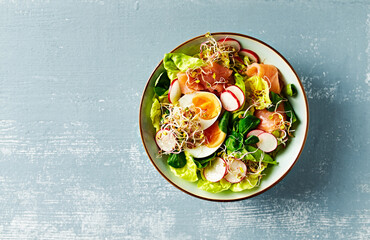 Wall Mural - Salmon and egg salad with leaf vegetables, radish and sprouts