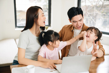 Wall Mural - Young Asian family at home