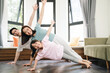 © Timeimage - Young Asian family exercise at home