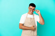 © luismolinero - Restaurant waiter man over isolated blue background with glasses and happy