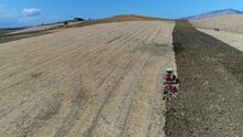 Aerial View Of Continuous Track Tractor Plowing Rough Soil Its Running On Two Belts Driven By More Wheels The Large Surface Area Of The Tracks Distributes The Weight Of The Vehicle Better 4k Quality