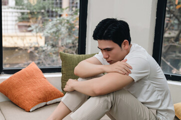 Image of young Asian man at home