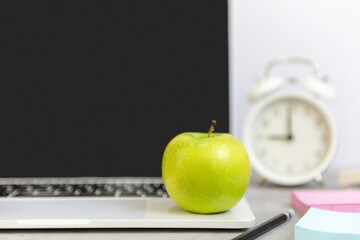 Wall Mural - Close up green apple.  Healthy snack for diet planning for working in office.  Fresh fruit dumbbell and laptop background.  Healthy Lifestyle Concept