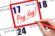 Hand writing text PAY DATE on calendar date January 17 and underline it. Payment due date
