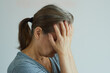 © evafesenuk - Retired woman covered her face with her hands, suffers from pain, depression, loneliness