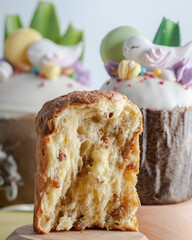 Easter cake with raisins and white fondant with birds and macaroons. on a light background with rabbits and flowers