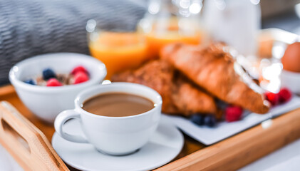 Wall Mural - A tray with breakfast on a bed in a hotel room