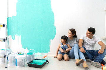 Wall Mural - Portrait of enjoy happy love asian family father and mother using a paint roller and painting walls, renovation, housework, diy, painting in their new home