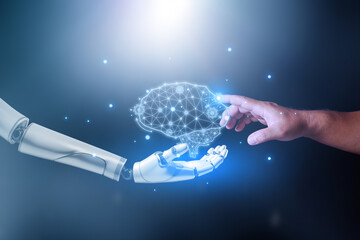 Machine learning, Hands of robot and human touching a Ai brain, Science and artificial intelligence technology, innovation and futuristic. Robotic holding a mechanical artificial intelligence brain.