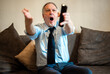 © Minerva Studio - Senor guy watching sports in tv and shouting