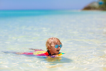 Wall Mural - Kids surf on tropical beach. Vacation with child.