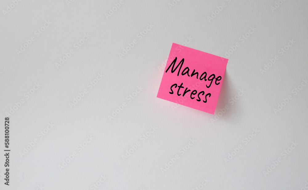 Manage stress symbol. Concept word Manage stress on pink steaky note ...