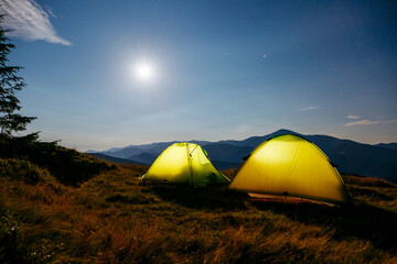 Wall Mural - the two tents in the foreground is highlighted from the inside. carpathian mountains, ukraine, europ