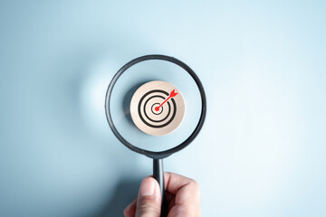 Magnifier glass focus to target icon which for planning development leadership and customer target group concept.