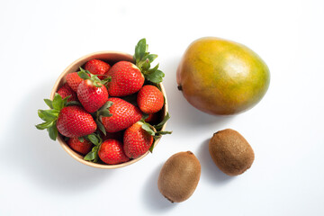 Wall Mural - Fresh fruits mango, strawberry kiwi on a white background. Top view, flat lay