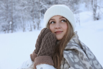 Wall Mural - Winter vacation. Beautiful woman near snowy forest outdoors. Space for text