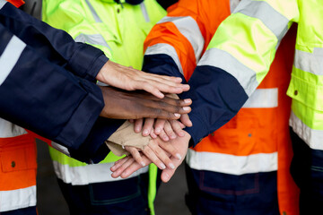 Closeup group of engineer team harmonious with hands stack for goal and success at factory industry, worker teamwork and community for harmony, technician join hands and support, industrial concept.