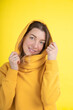 © Татьяна Волкова - Yellow is color of positive emotions. Attractive 40-year-old woman in yellow hoodie on yellow background in studio.