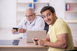 © Elnur - Young male patient visiting old male doctor