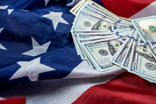 Close Up Of American Flag And Dollar Cash Money.
