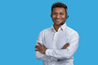 © DenisProduction.com - Portrait of indian man with folded arms wearing headset. Isolated on blue.