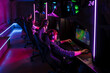 © Drobot Dean - Team of gamers playing online video game in cybersport club