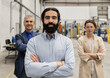 © Westend61 - Confident engineers with arms crossed standing in industry