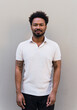 © Westend61 - Man wearing polo t-shirt standing in front of wall