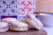 Selective focus on Buttery Cornstarch cookies filled with dulce de Leche and grated coconut.