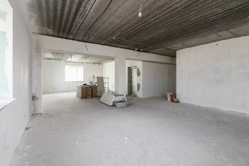 Spacious empty rooms in the attic floor after filling out the work on the wall and ceiling