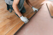 © standret - Man is installing new laminated wooden floor