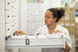 © AUFORT Jérome - young woman pharmacist checking her stock