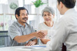 © SKW - Asian seniors who are healthy, in a good mood, smiling, talking with financial or life insurance staff to take care of life after retirement.