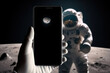 Astronaut holding smartphone standing on the Moon, generative ai