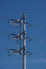 Wall Mural - Electricity pylon and power lines under blue sky