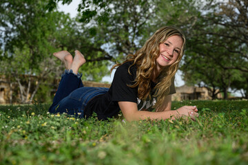 young pretty teenage girl posing in a historic setting for her high school graduation photos