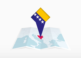 bosnia and herzegovina is depicted on a folded paper map and pinned location marker with flag of bos