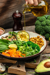 Sticker - Girl holding plate with hands vegan breakfast. meal in bowl with avocado, mushrooms, broccoli, spinach, chickpeas, pumpkin. top view