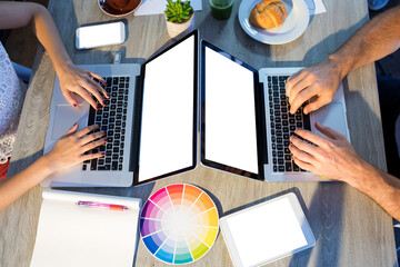 Canvas Print - High angle view of executives using laptop at desk