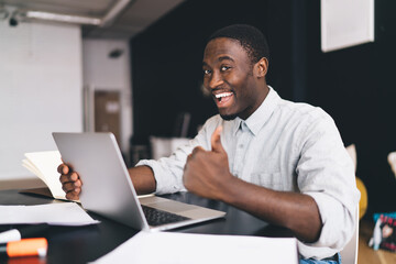 Excited black man showing thumb up