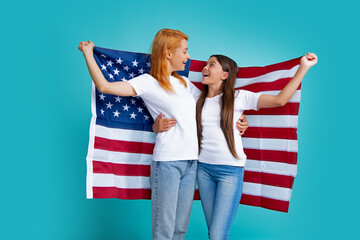 Poster - Excited mom and child hold American flag. Mother and daughter child girl teenager with American flag. USA celebrate 4th of July. Independence Day. Patriotic US holiday concept.