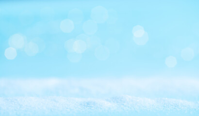 snow on a blue background with light. winter banner.