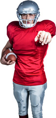 Wall Mural - Portrait of confident sportsman pointing while holding American football