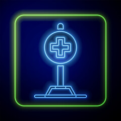 Sticker - Glowing neon Medical map pointer with cross hospital icon isolated on blue background. Vector