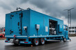 Industrial mobile diesel generator for office building, connected to electrical network by cable, created with Generative AI