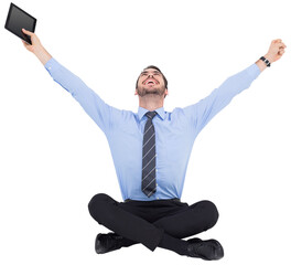 Wall Mural - Businessman cheering and holding his tablet