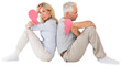 Unhappy couple sitting while holding broken heart