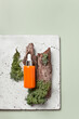 Beauty face serum flatlay with wood and moss on the foreground copy space, earthy tones